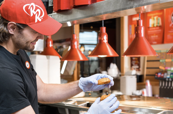 Employee assembling a sandwich