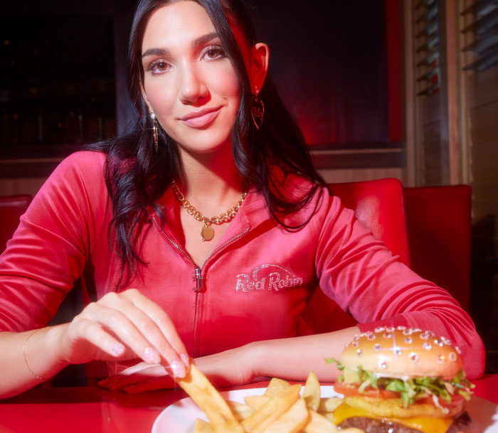 Guest enjoying Bottomless Steak Fries in Juicier track suit.