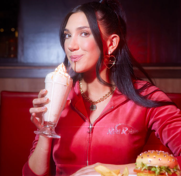 Guest enjoying a Milkshake in a Juicier track suit