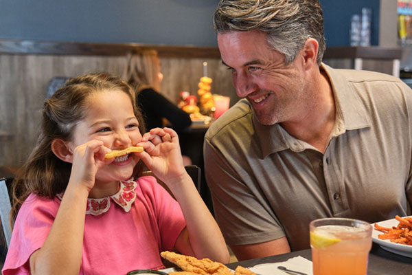Dad and daughter enjoying Bottomless Fries