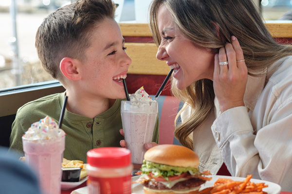 Mom and son enjoying a milkshake at Red Robin