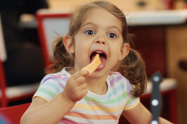 Young girl enjoying steak fries