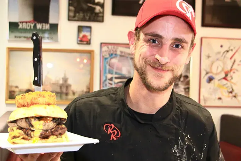 Team Member showing off his burger creation