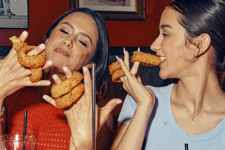 Mom and daughter enjoying Red Robin onion rings