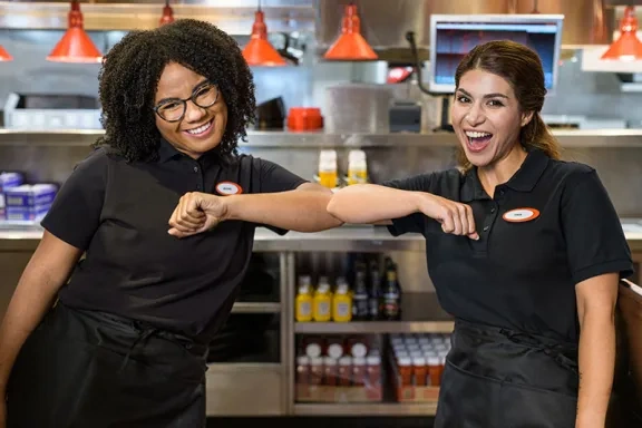 Team Members give a chicken wing