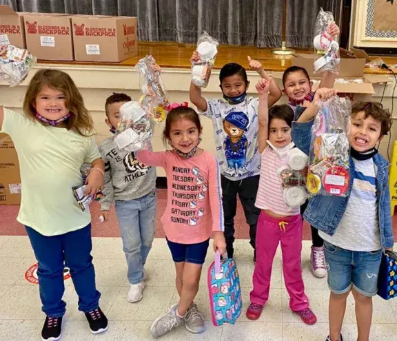 group of kids with blessings in a backpack