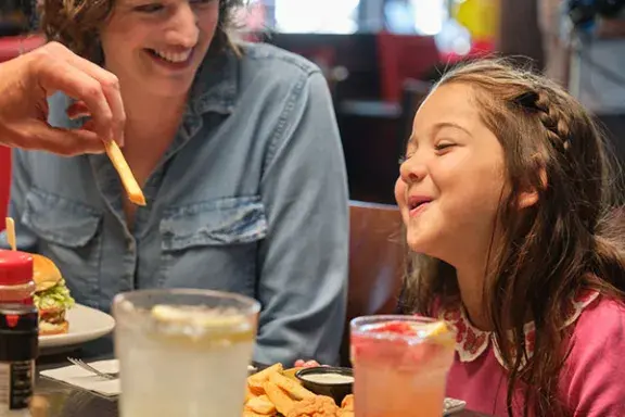 Mother and daughter enjoying Red Robin meal