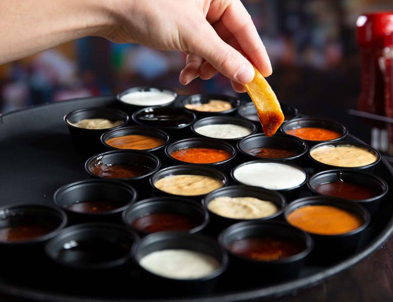 Dipping a Steak Fry into an array of sauces