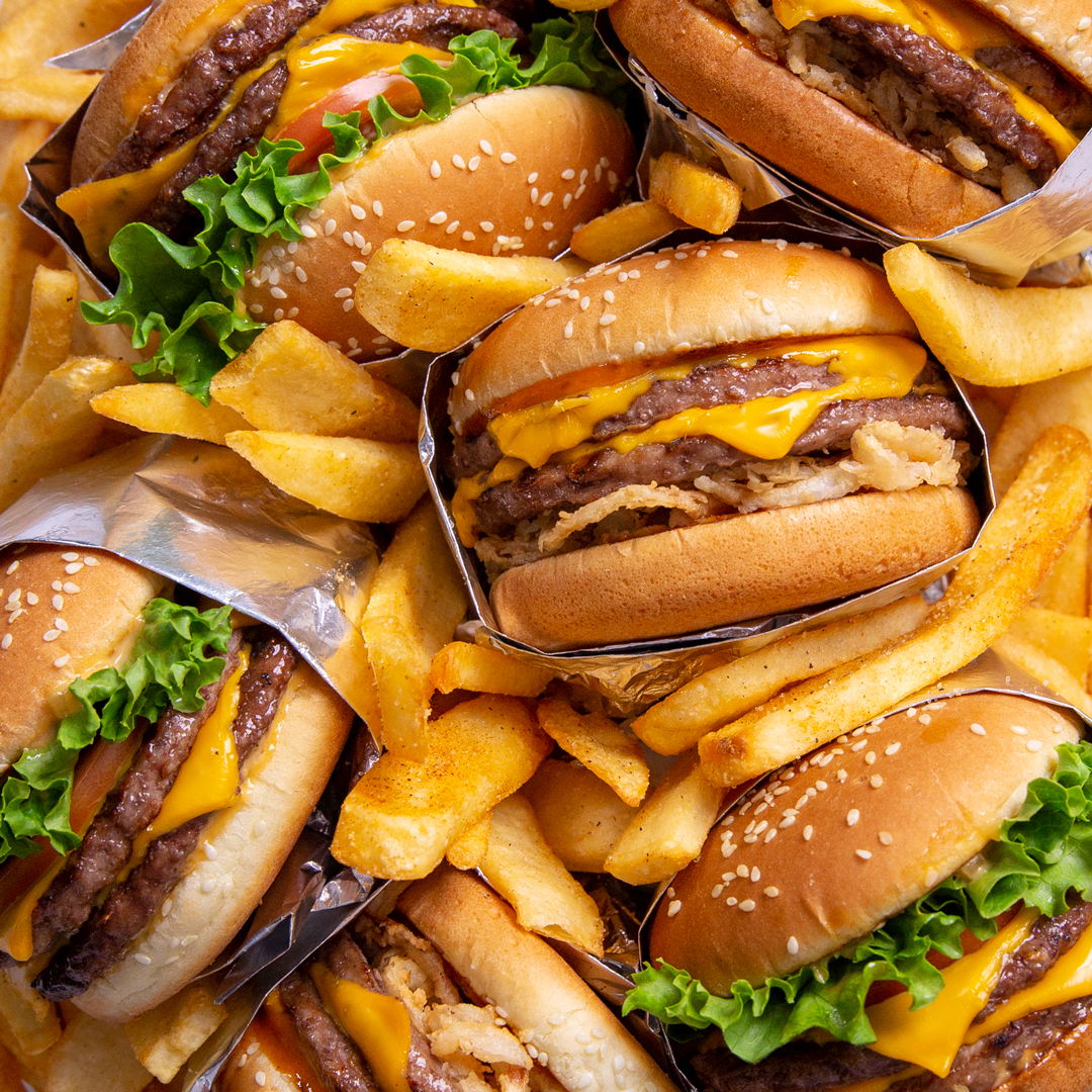 Tavern Burgers nestled in a bed of Bottomless Steak Fries